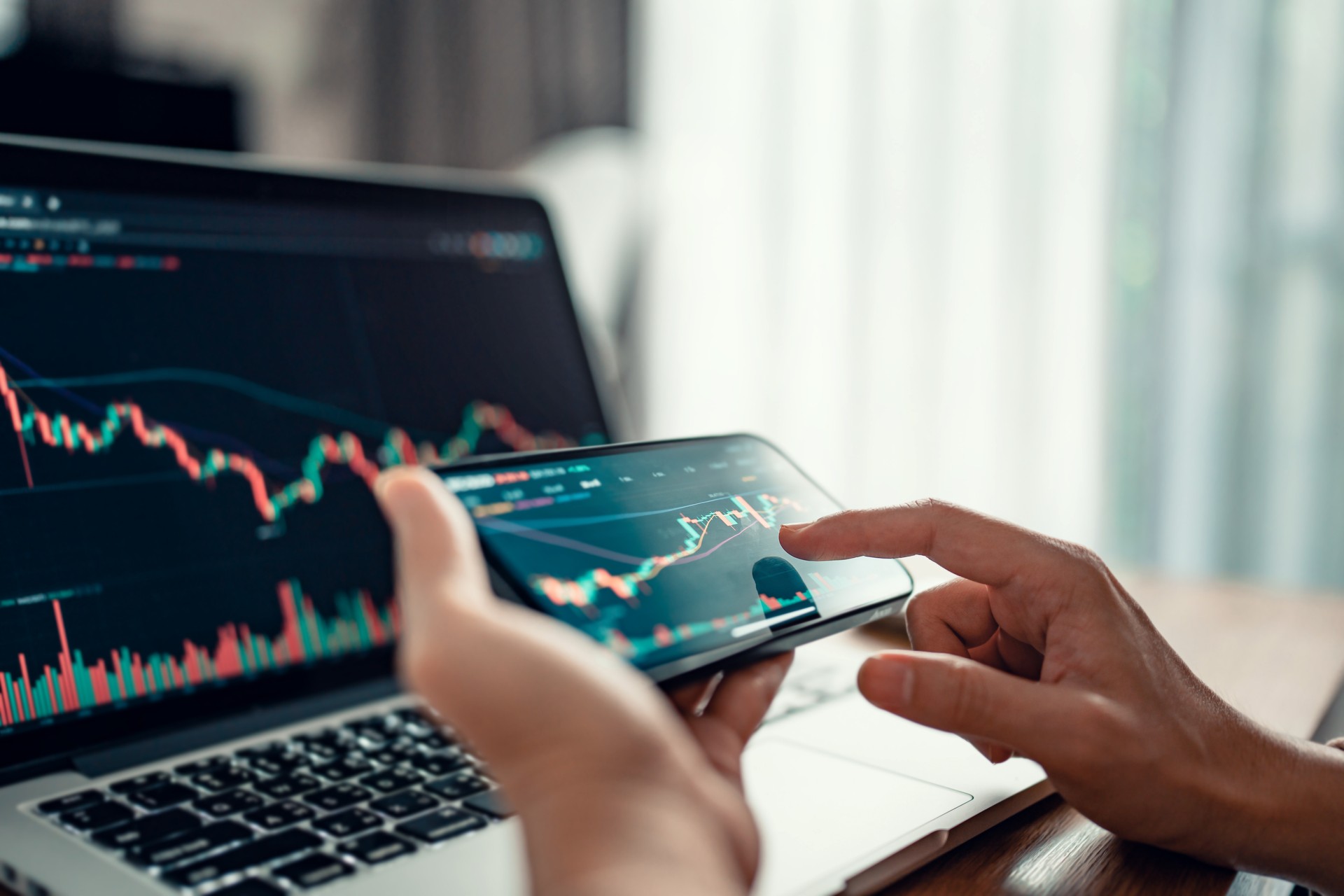 Woman is checking Bitcoin price chart on digital exchange on smartphone, cryptocurrency future price action prediction.